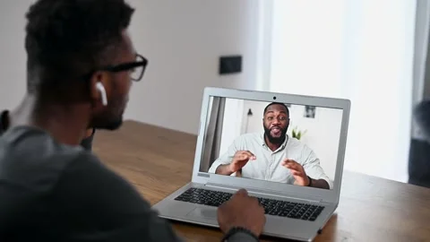An African guy using laptop for video call Stock Footage 146231389