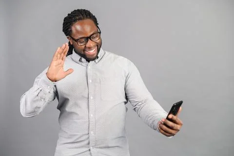 African guy using smartphone for video call Stock Photos