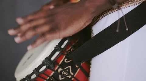 African hands banging on a drum Stock Footage 64296269