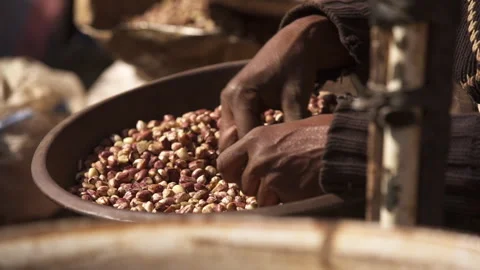 African hands sorting nuts in a basket Stock Footage 258589235