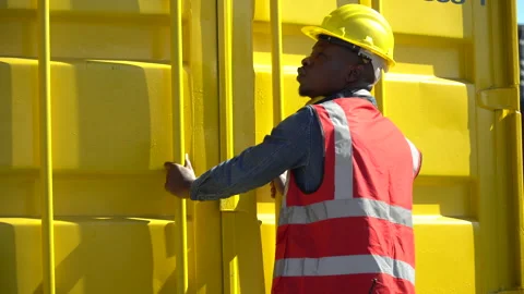 African harbor worker checking list quality and closing  Containers box tog.. Stock Footage 242309203