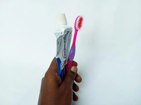African holding empty Pepsodent toothpaste tube, used, red, pink toothbrush o Stock-Fotos