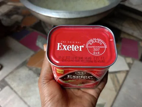 African holding tin of Exeter corned beef Stock Photos