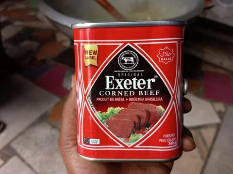 African holding tin of Exeter corned beef Stock Photos