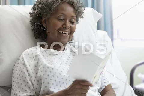 African hospital patient reading greeting card Stock Photos