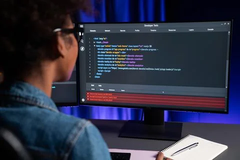 African IT developer concentrating codding program on laptop screen. Tastemaker. 스톡 사진