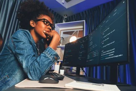 African IT developer concentrating codding program on laptop screen. Tastemaker. Stockfoto's