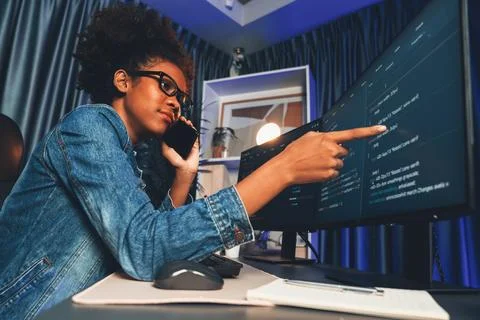African IT developer concentrating codding program on laptop screen. Tastemaker. Stockfoto's
