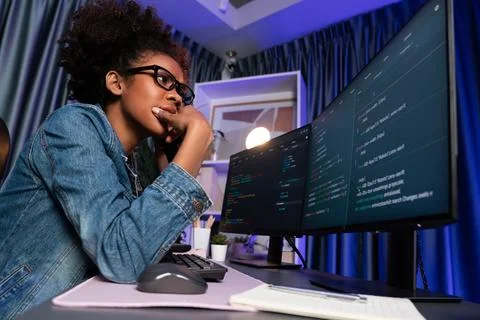 African IT developer concentrating codding program on laptop screen. Tastemaker. 스톡 사진