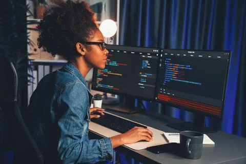 African IT developer concentrating codding program on laptop screen. Tastemaker. 스톡 사진