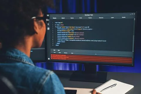 African IT developer concentrating codding program on laptop screen. Tastemaker. 스톡 사진