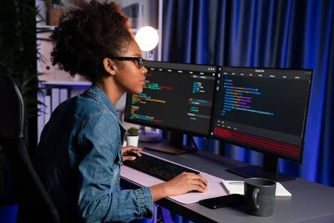 African IT developer concentrating codding program on laptop screen. Tastemaker. 스톡 사진