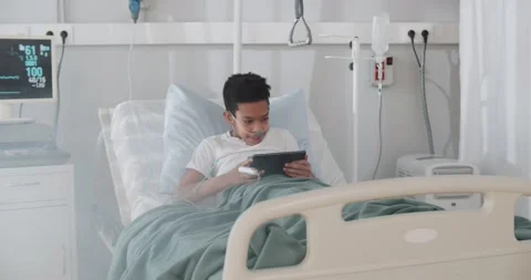 African kid patient using digital tablet on bed in hospital Stock Footage 149313412