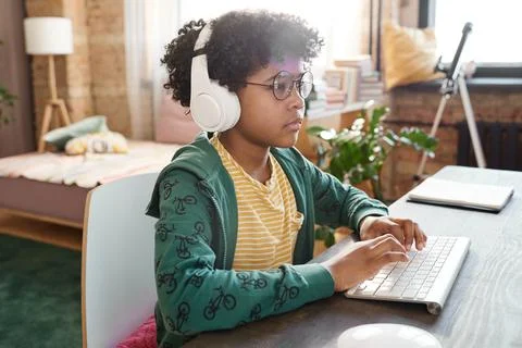 African kid using computer for online game 스톡 사진