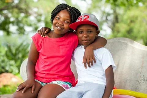 African kids sitting together on bench. Stock Photos