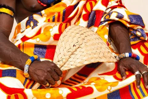 African king is sitting while holding a traditional hand fan 스톡 사진