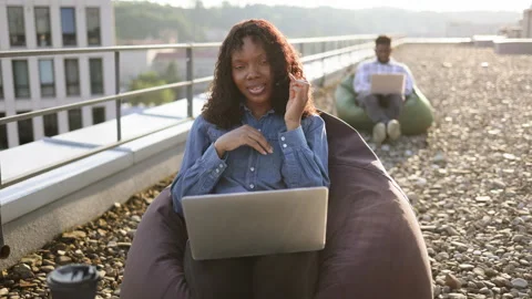 African lady looking at camera using portable computer and headset. Video stock 266060124