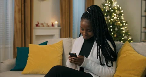 African-looking student dressed in black clothes and white cardigan sitting on Stock Footage 200856476