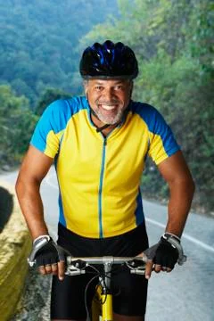 African male cyclist riding bicycle Stock Photos