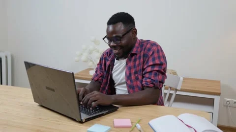 African male e-learning student with online teacher talking to teacher on Stock Footage 157925367