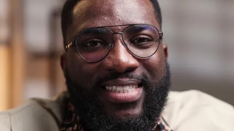 African man with a beard and glasses smiling broadly, expressing joy Stock Footage 346777176