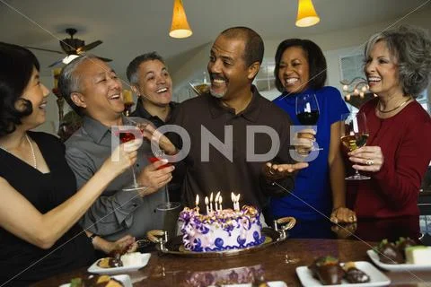 African Man Celebrating Birthday With Multi-Ethnic Friends