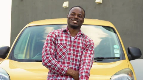 African man with charging cable at electro charging station near cargo electric Video stock 249086569