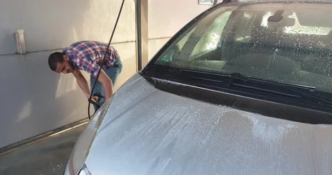 African man cleaning his car Stock Footage 149381453
