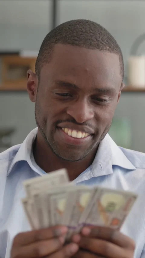 African Man Counting Money while Sitting on Sofa at Home Stock Footage 301856984