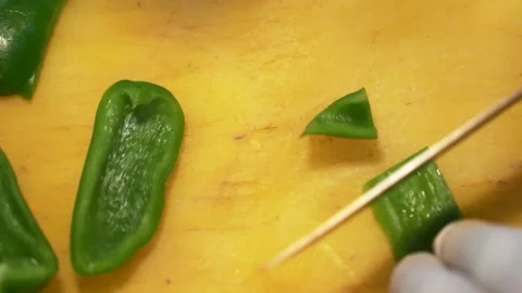 African man cutting vegetables with a sharp knife using a yellow cutting board Video stock 230080500