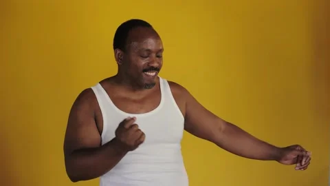 African man dancing against a yellow background.  Stock Footage 201291885