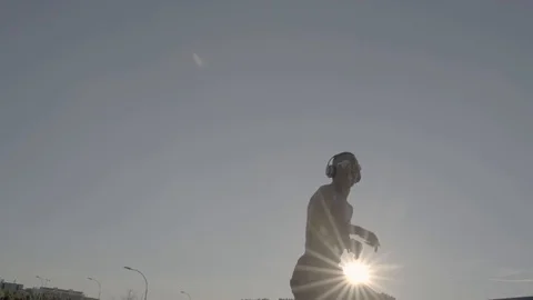 African man dancing in the sunny day. Use some headphones Stock Footage 105503516