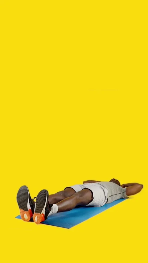 African man doing crunches alternating leg with bicycle Stock Footage 245608914