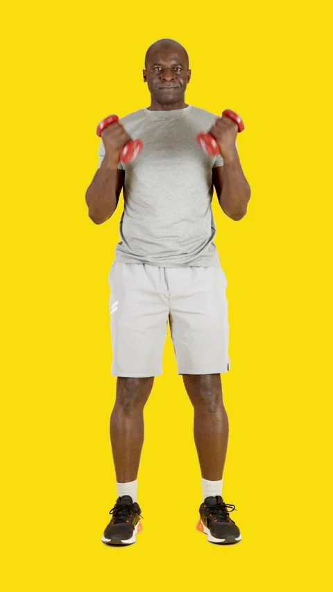 African man doing curl biceps with dumbbells Video stock 243556415