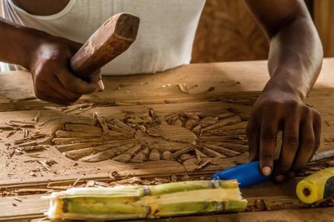 African man doing his work makes a carver door Stock Photos