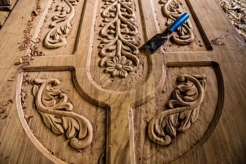 African man doing his work makes a carver door Stock Photos