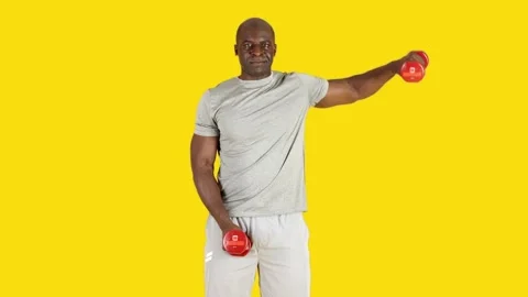 African man doing lateral alternate raise exercises with dumbbells Stock Footage 244698527