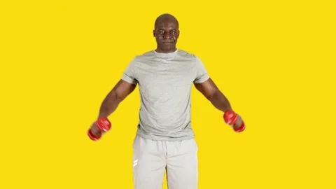African man doing lateral raise exercises with dumbbells Stock Footage 242312361