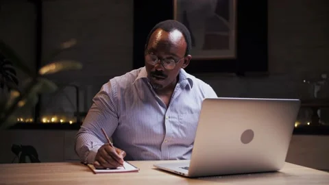 African man doing online learning at home.Business person work remotely using Stock Footage 209224578
