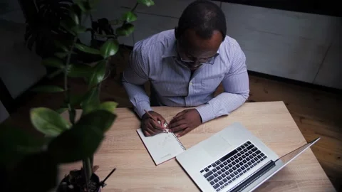 African man doing online learning at home.Business person work remotely using Stock Footage 209224662