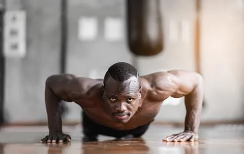African man doing push up exercise at the gym. Sport man exercise at the gym. Stock Photos