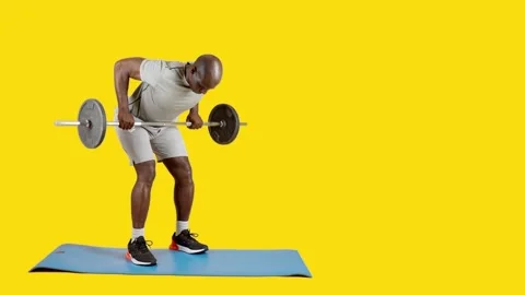 African man doing row exercises with a bar with weights Stock Footage 242911017