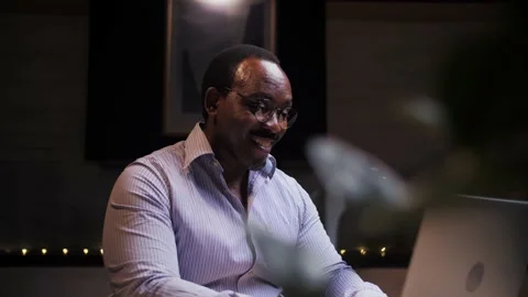 African man doing video call using laptop sitting at home.Business person doing Stock Footage 209224735