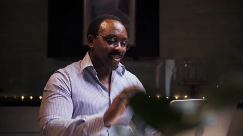 African man doing video call using laptop sitting at home.Business person doing Stock Footage 209224956