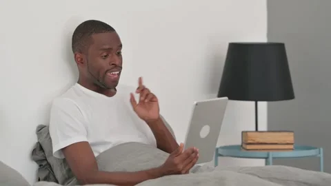 African Man Doing Video Chat on Tablet while Sitting in Bed Stock-Footage 287909204