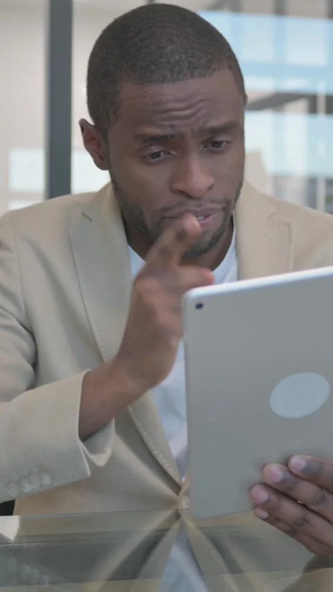 African Man Doing Video Talk on Digital Tablet in Office, vertical video Stock Footage 324791858