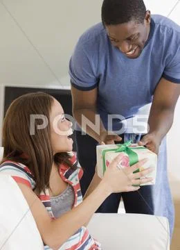 African Man Giving Gift To Girlfriend