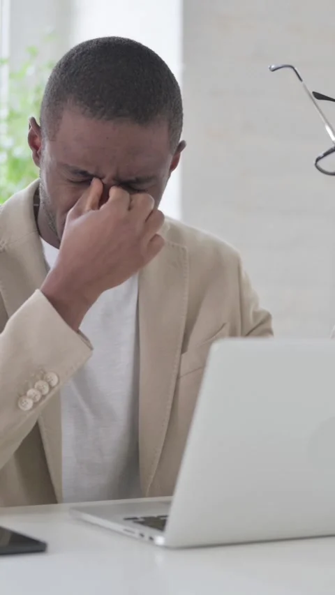 African Man having Headache while Working on Laptop, Vertical Video Stock Footage 337350278