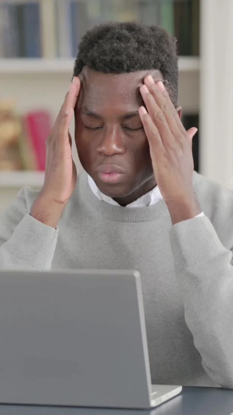 African Man having Headache while Working on Laptop, Vertical Video Stock Footage 339576057