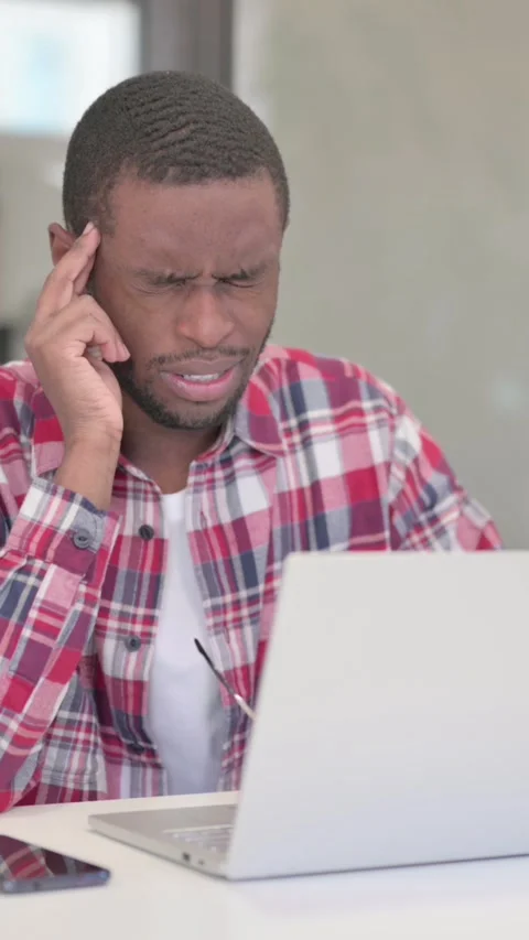 African Man having Headache while Working on Laptop, Vertical Video Stock Footage 340040143